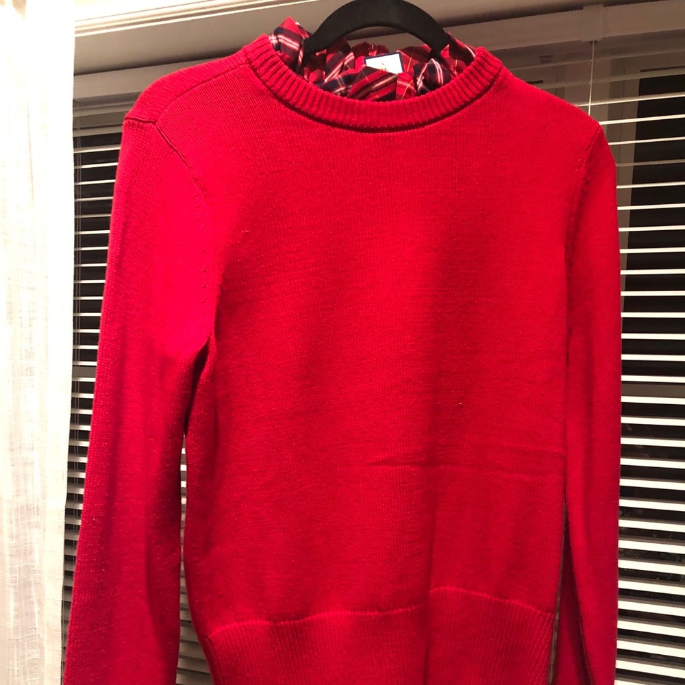 Red sweater with plaid shirt collar and cuffs